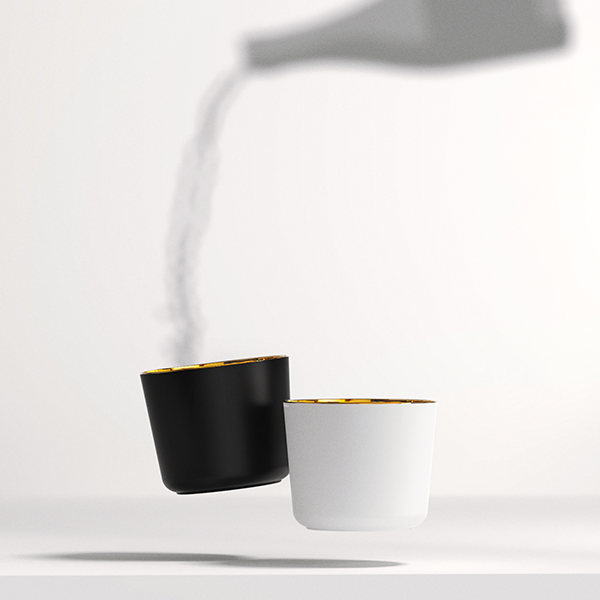 Schwarze und weiße Becher mit goldenen Rändern, Flüssigkeit wird darüber gegossen. Fürstenberg Porzellan.