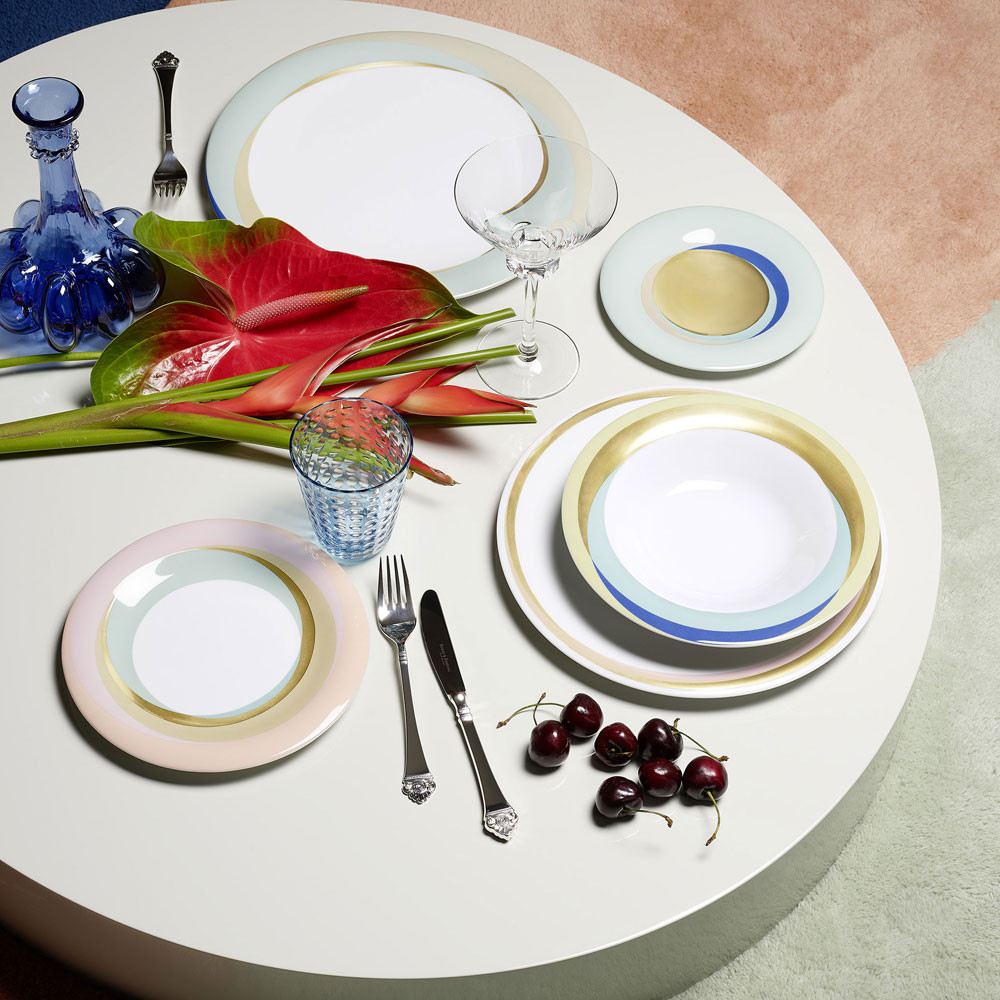 Plates with pastell colour on a white table