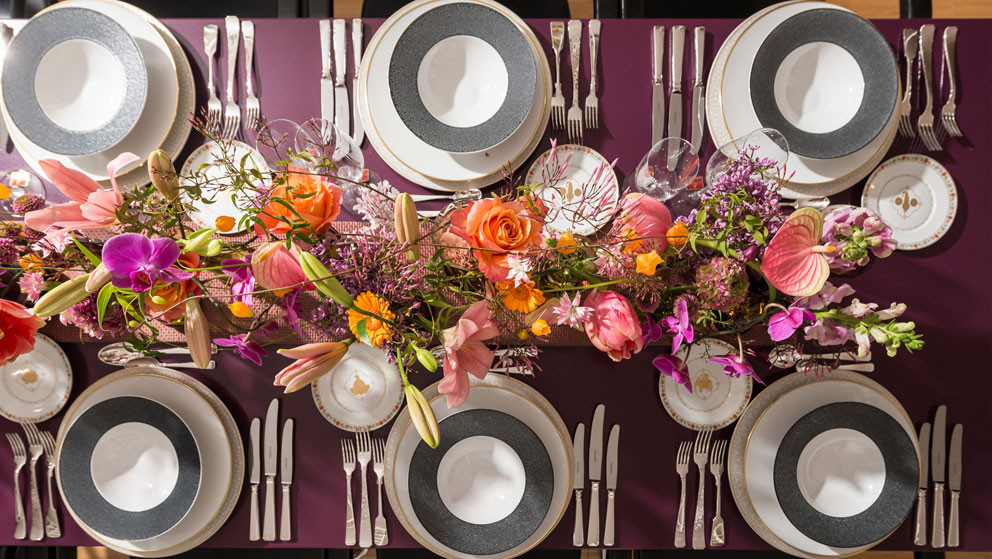 Layed table with plates and flowers in the middle