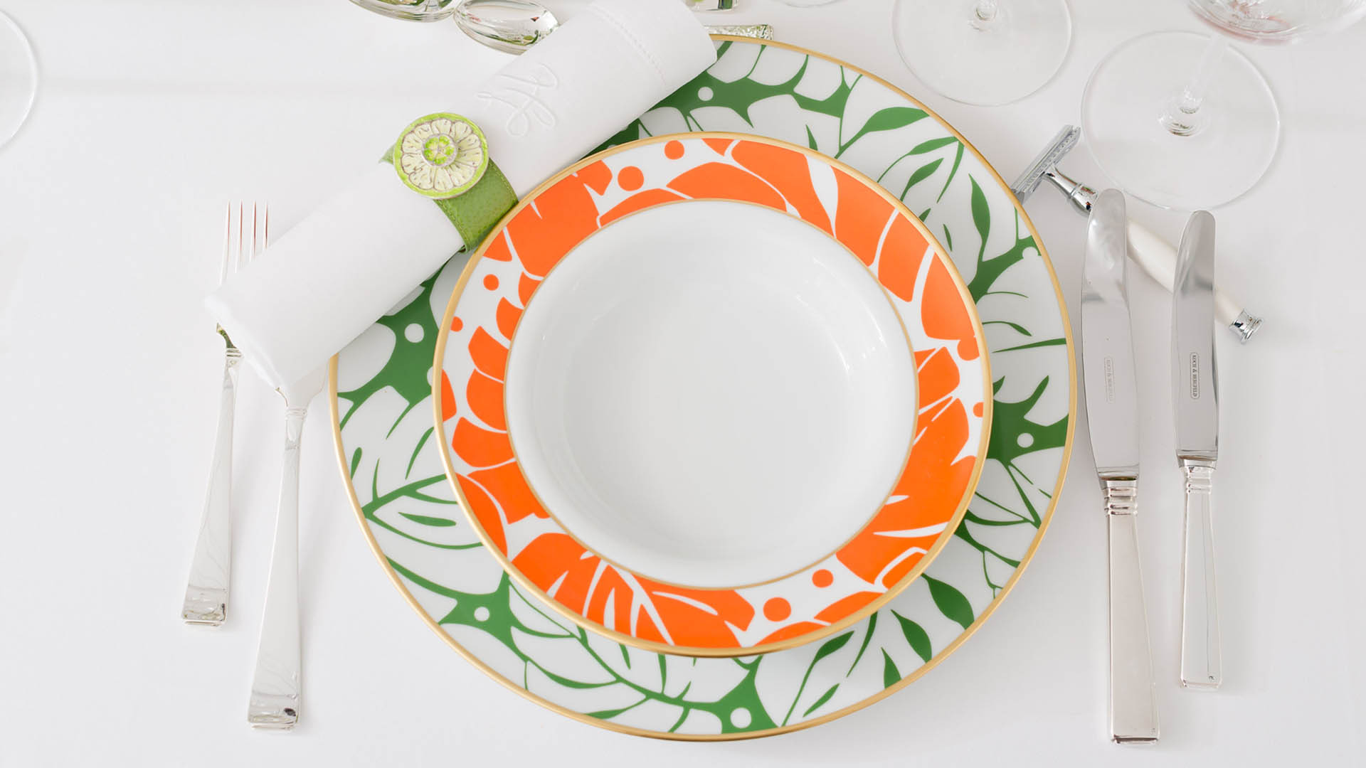 Table with dinner plates and colorful flowers